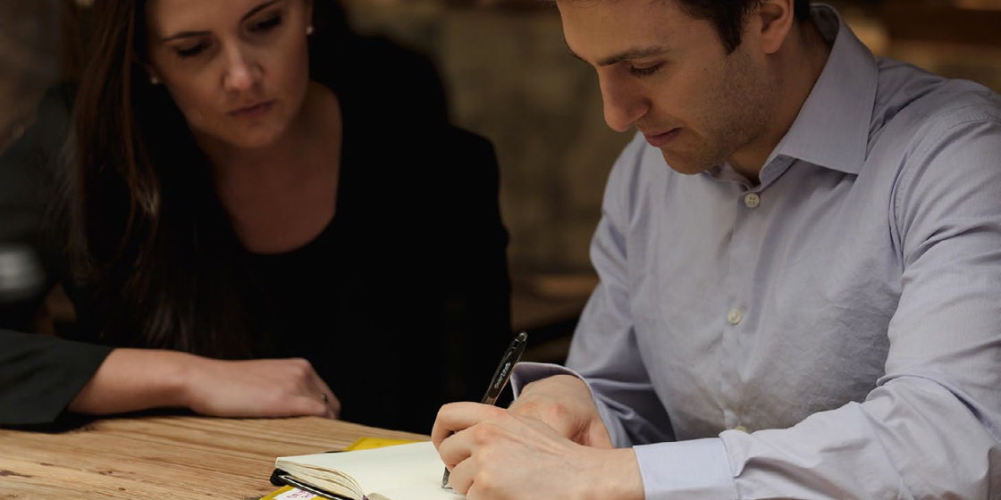 Photo of two employees writing notes in New York City